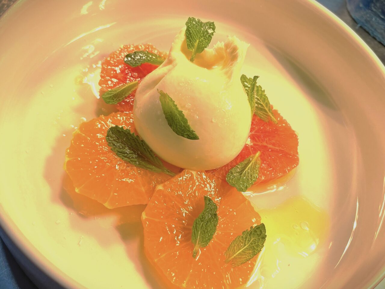 Burrata on a bed of citrus fruits